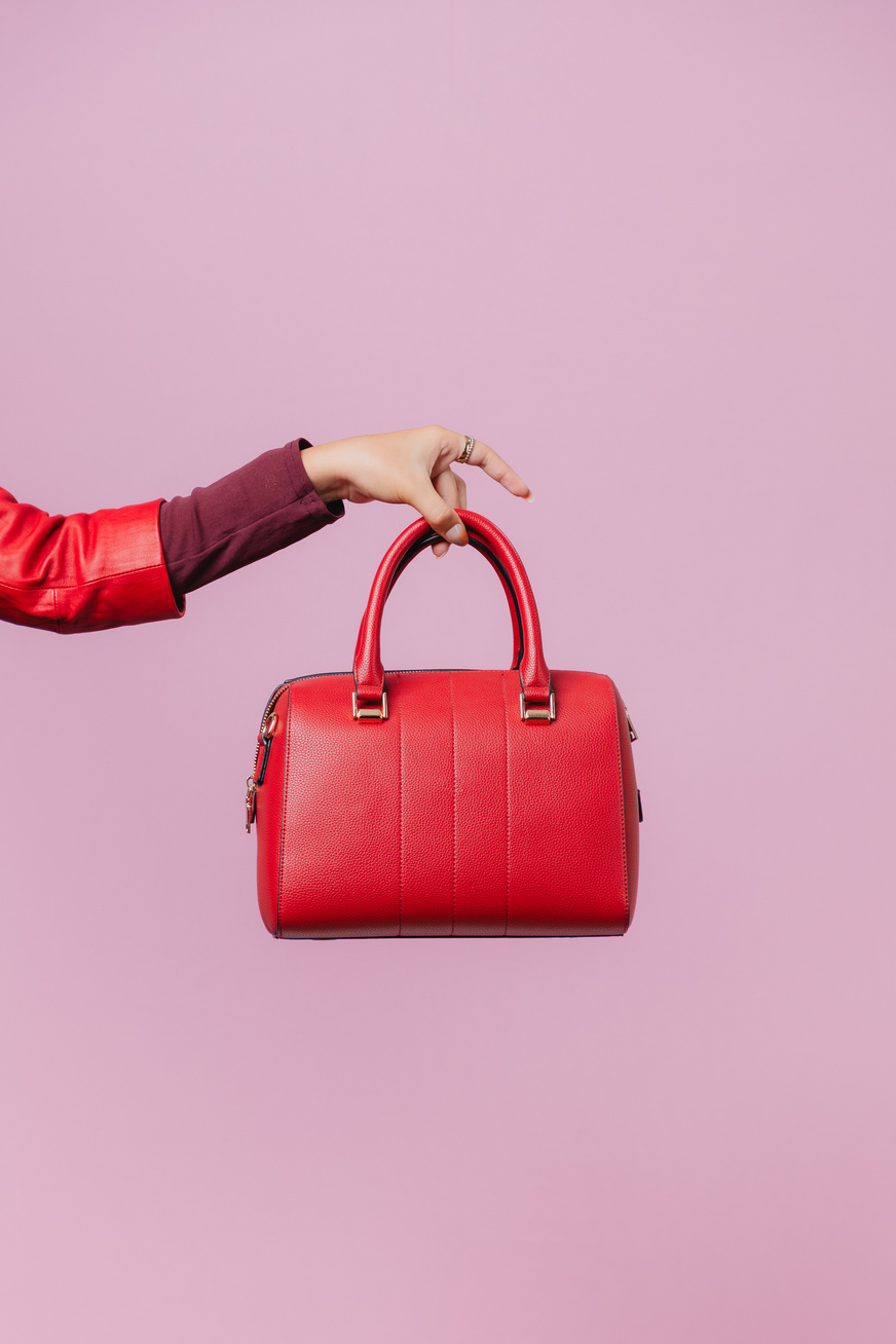 Hand Holding a Stylish Red Bag  